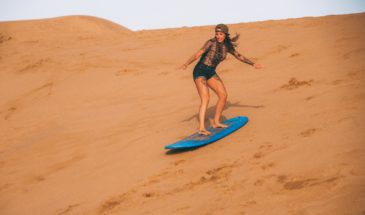 Surf girl in Morocco, sandboarding during a surf holiday to Morocco with the surfcamp in Taghazout Surf Paradise Morocco.